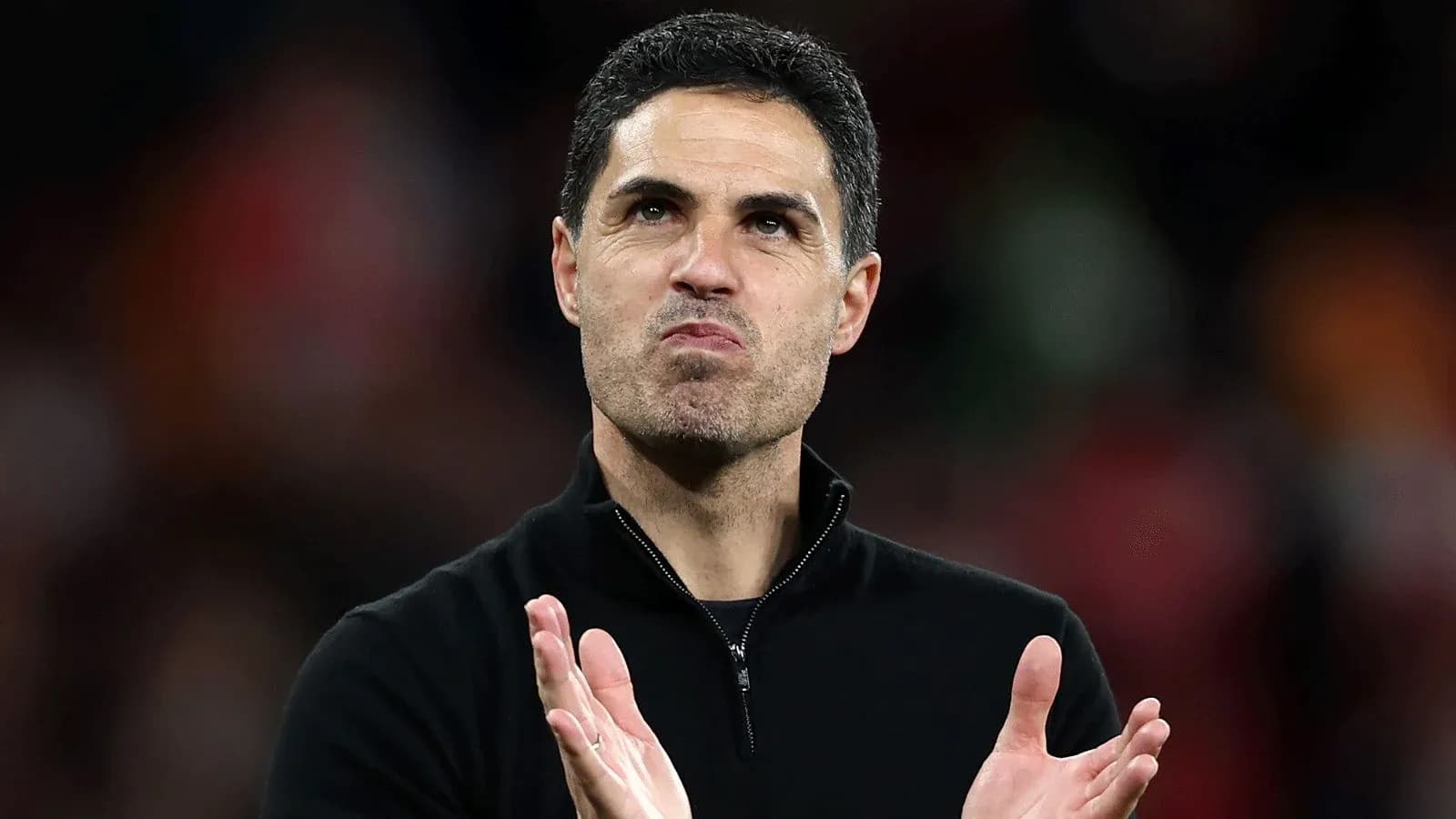 Manager clapping after match in stadium