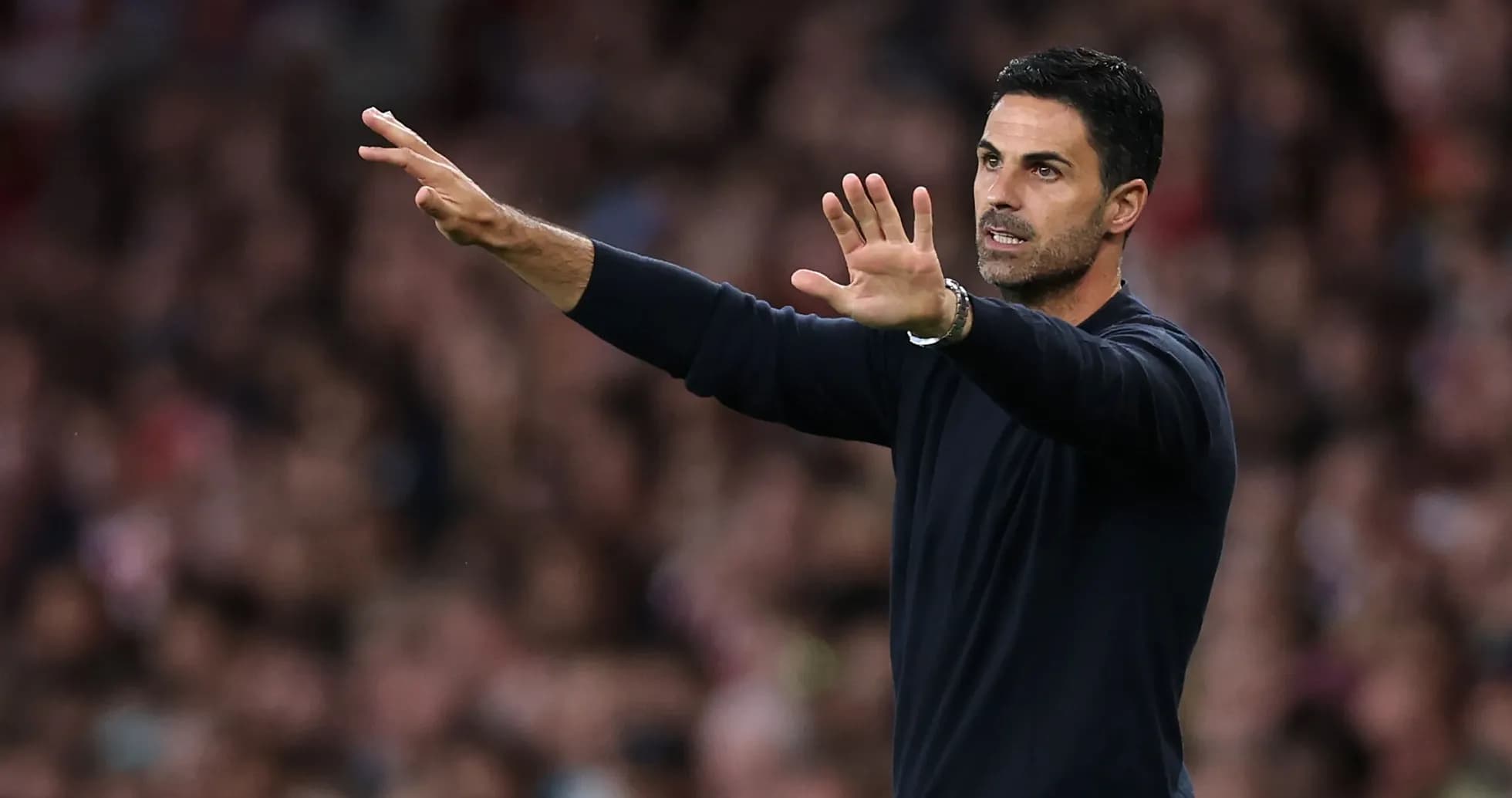 Manager gesturing on the sidelines during match