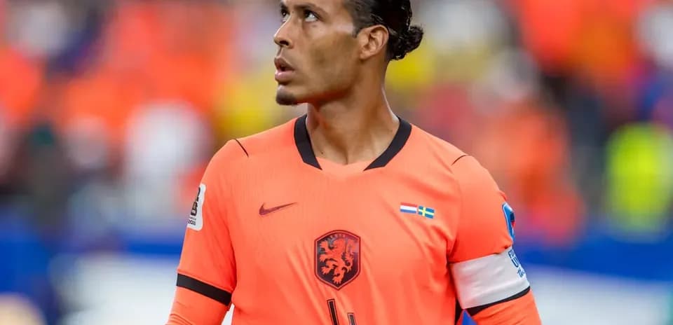 Player wearing orange jersey looking up during match