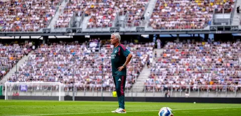 Coach standing on the sideline during match