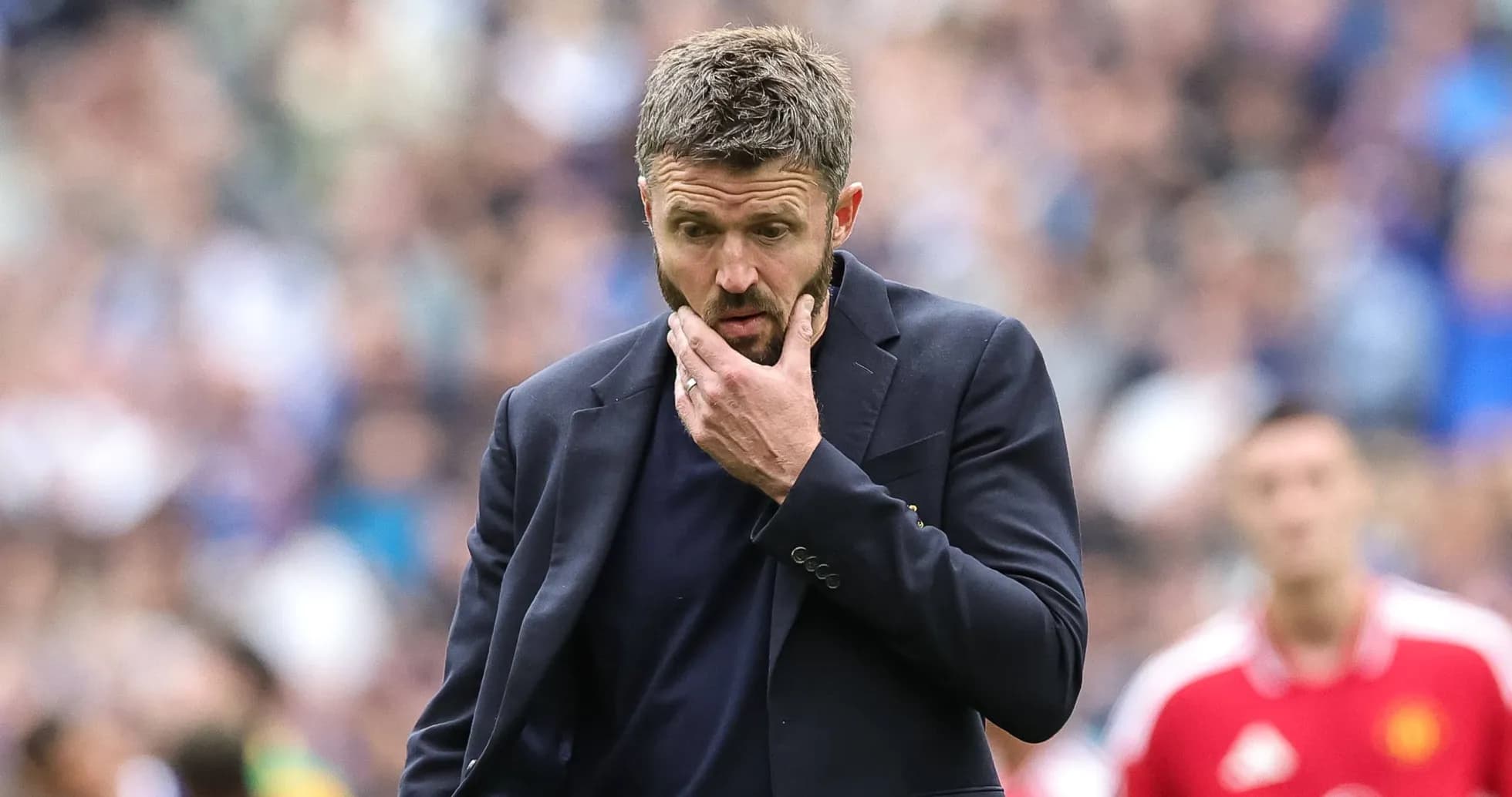 Coach contemplating during a football match