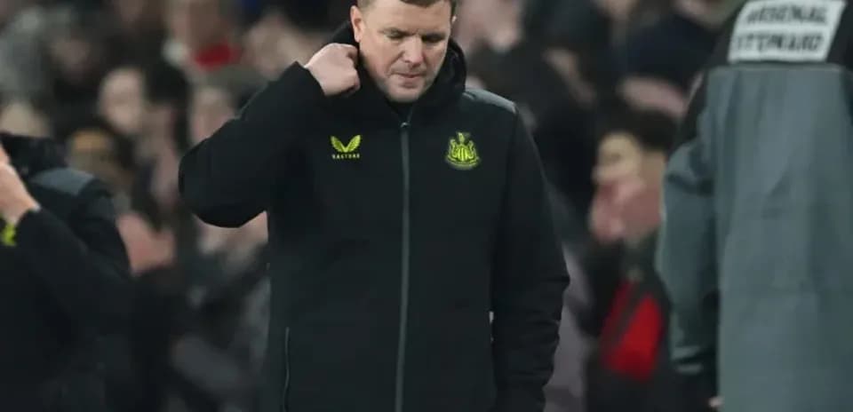 Newcastle manager walking with head down on pitch