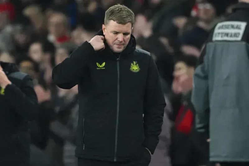Newcastle manager walking with head down on pitch