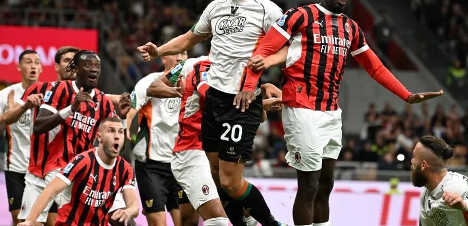 Players competing for the ball during AC Milan match