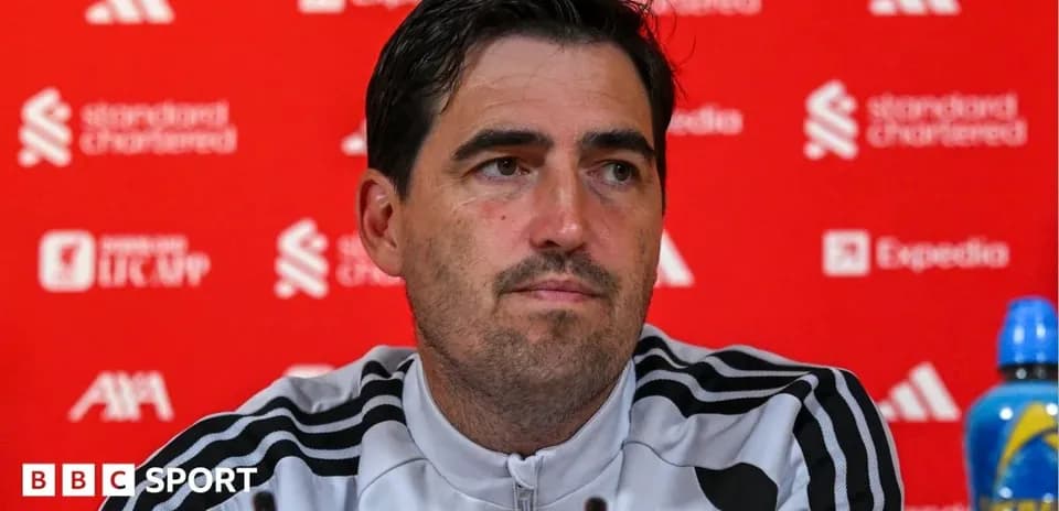 Manager speaking at press conference with sponsors' backdrop