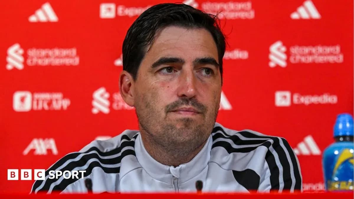 Manager speaking at press conference with sponsors' backdrop