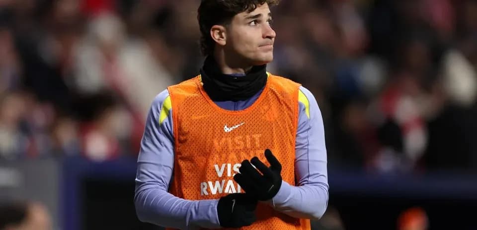 Player in training bib on sidelines during match