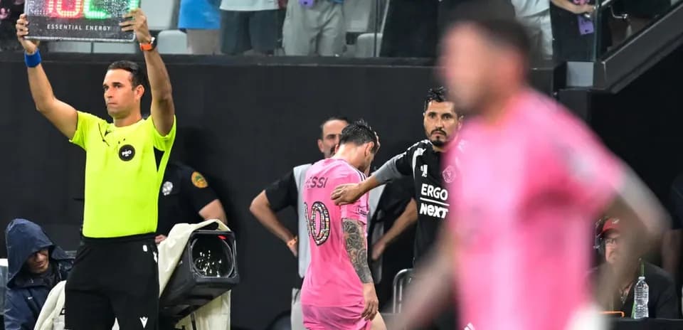 Substitution occurring with Messi leaving the field