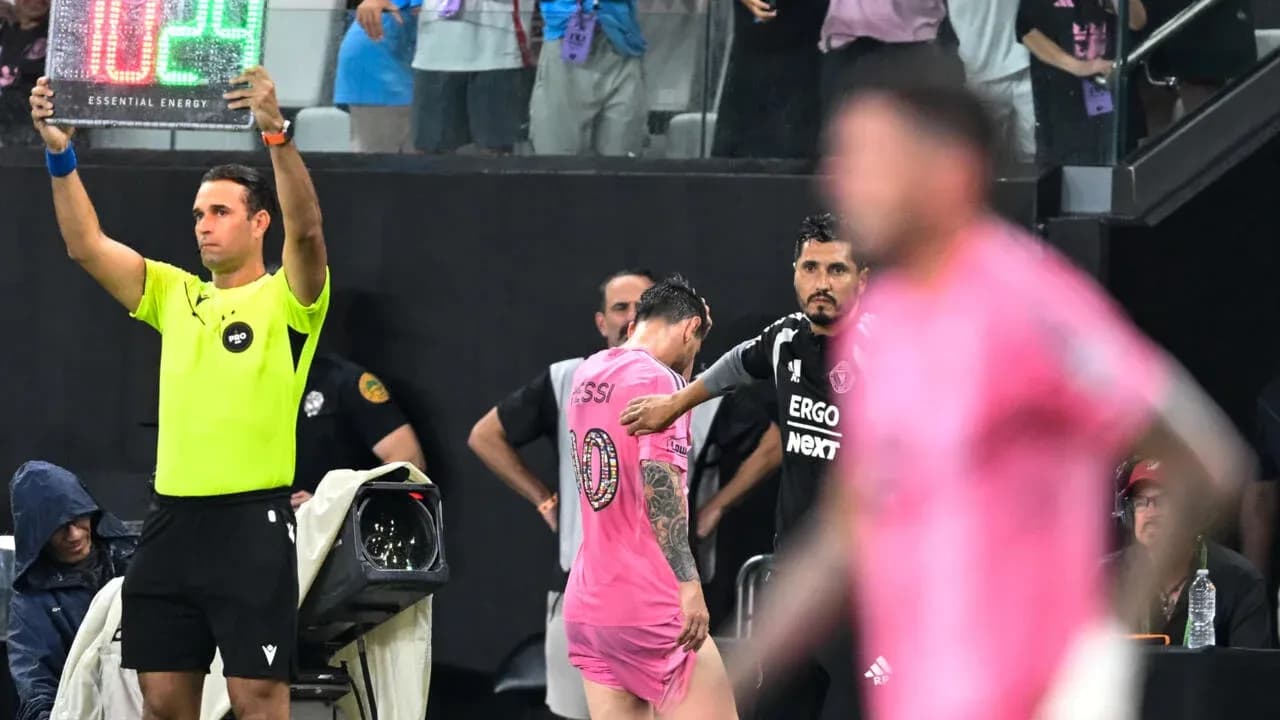 Substitution occurring with Messi leaving the field