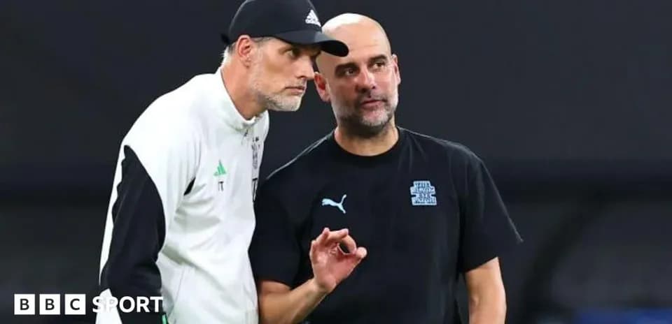 Two football managers discussing strategies on the field