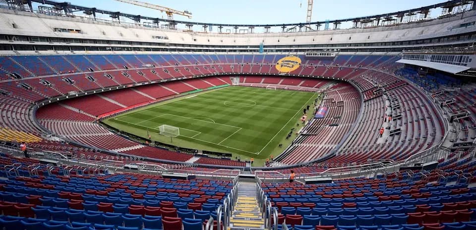 Empty stadium view with green pitch and seating