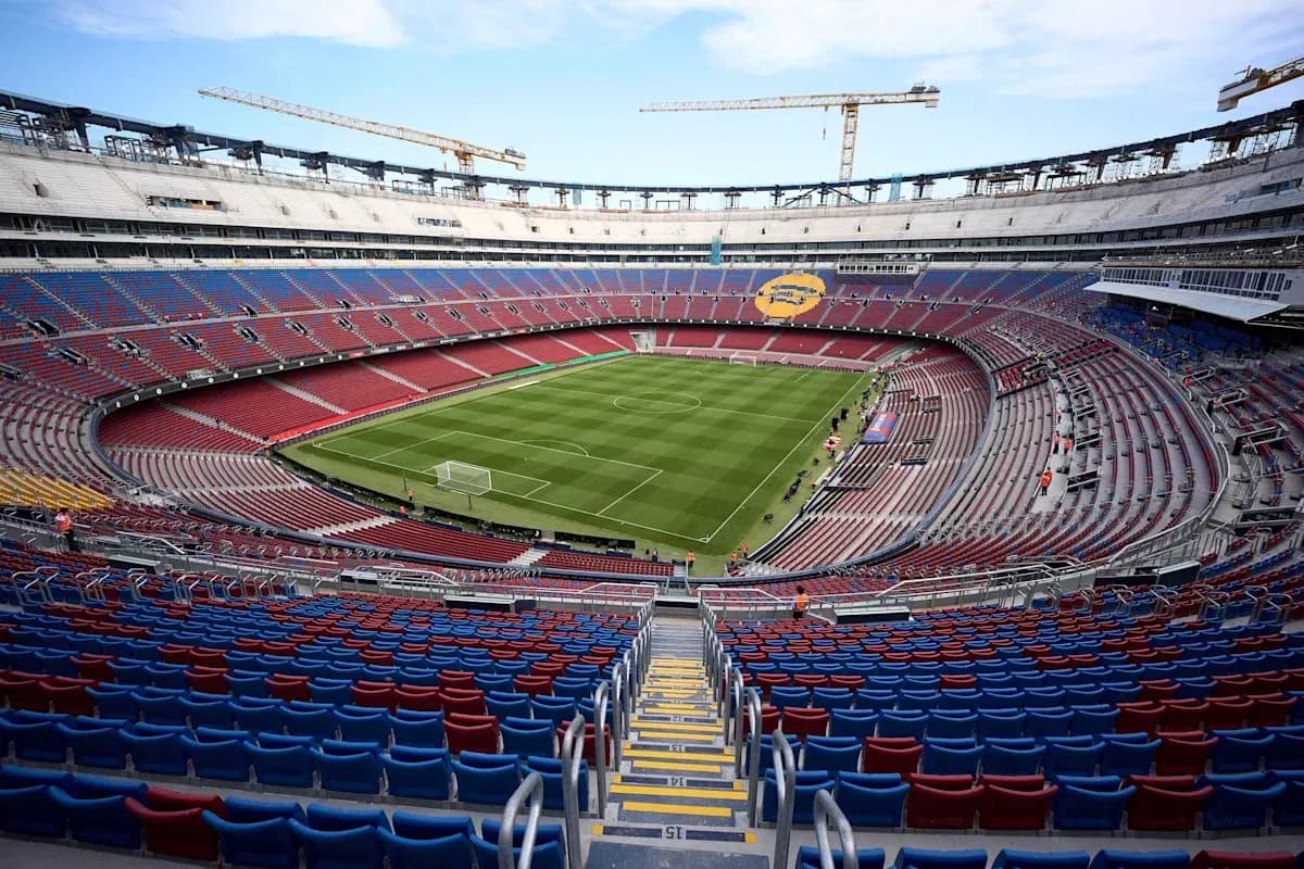 Empty stadium view with green pitch and seating