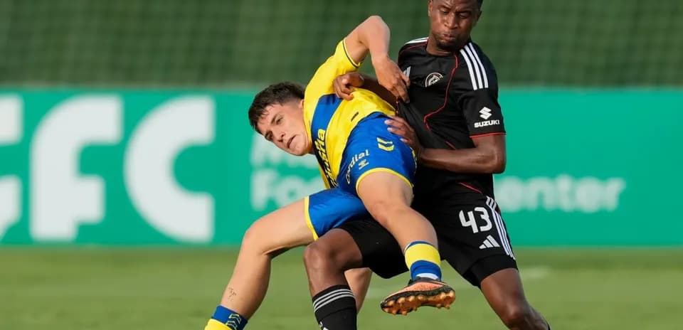 Two players contesting the ball on the field