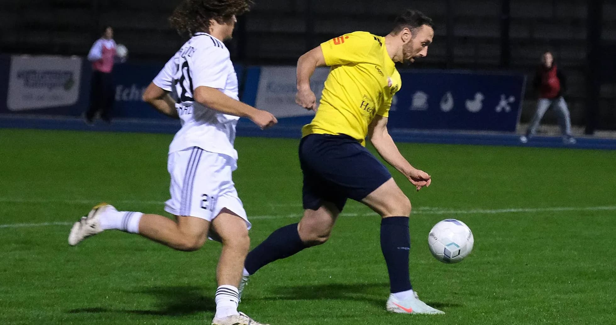 Player dribbling the ball in football match