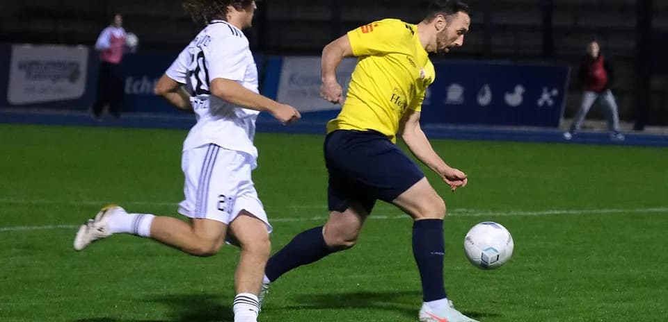 Player dribbling the ball in football match