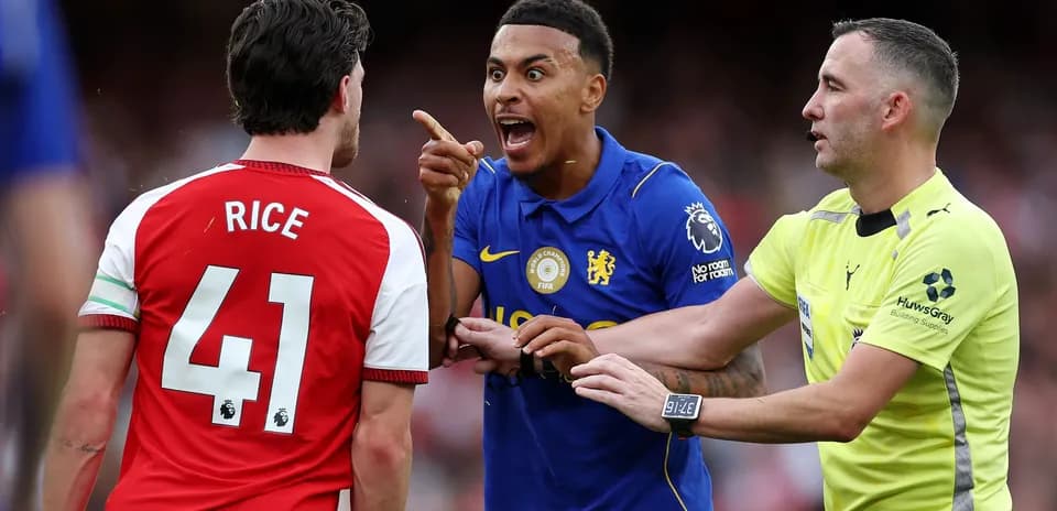 Players arguing with referee during football match