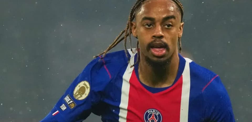 Player running in PSG jersey during match