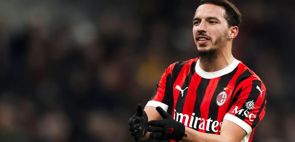 Player in AC Milan jersey celebrating on the pitch