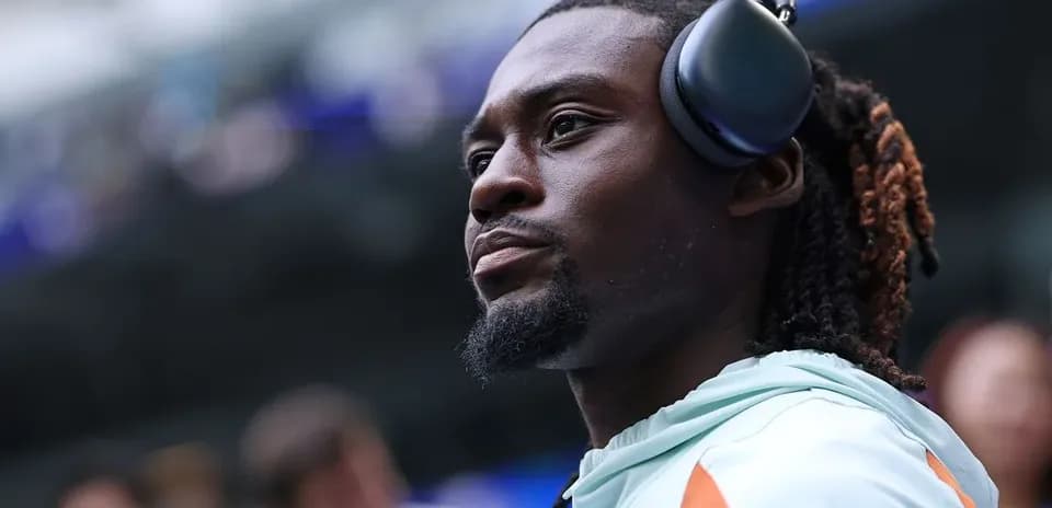 Player wearing headphones on sidelines before game