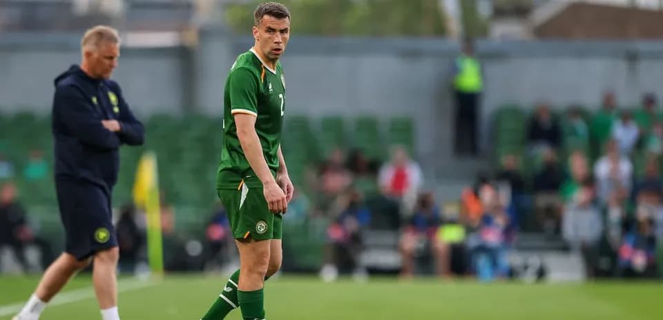 Ireland player on field with coach observing
