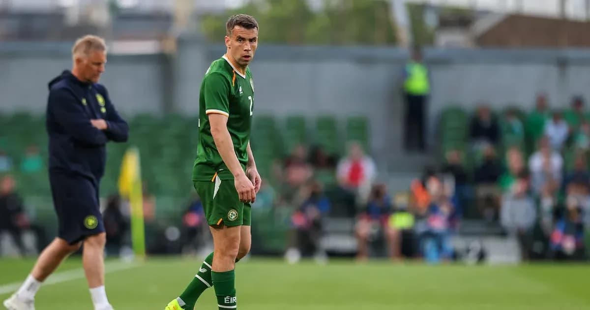 Ireland player on field with coach observing