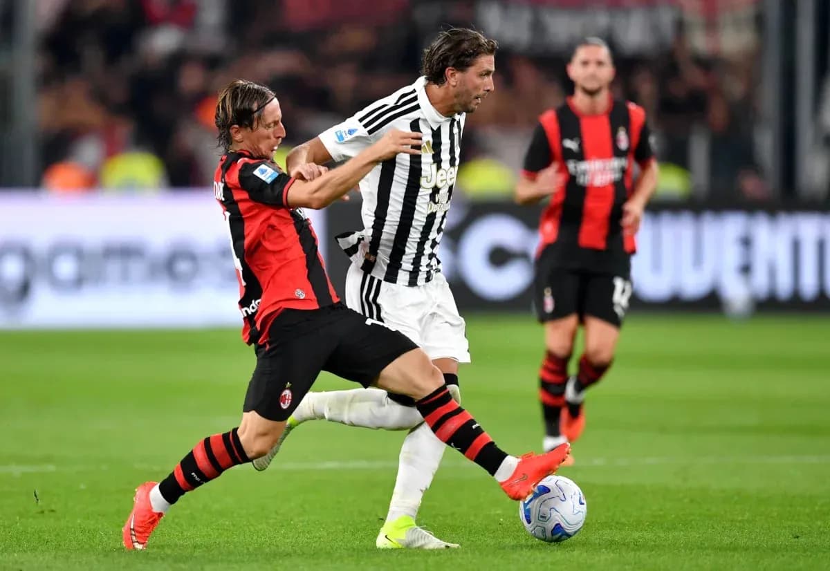 AC Milan player tackling Juventus player during match