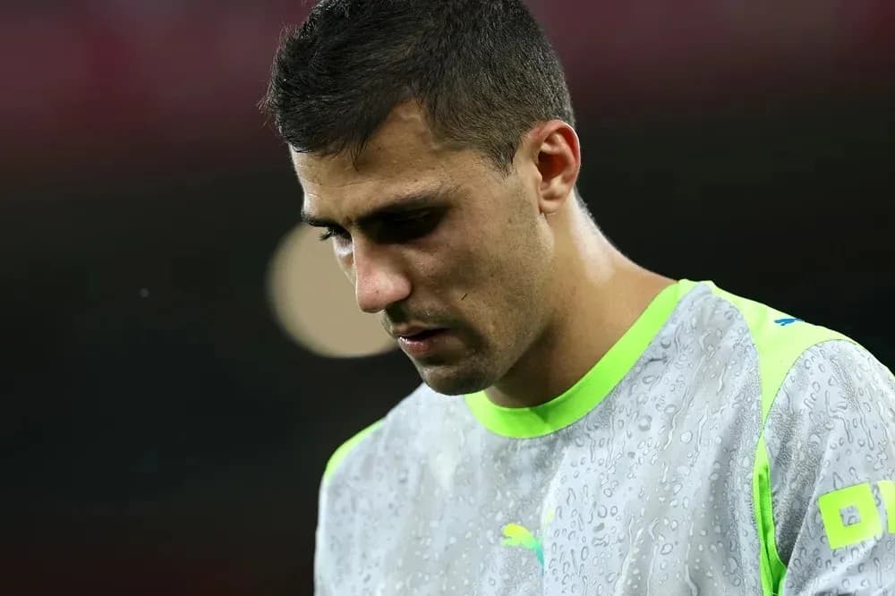 Player in training gear looking down during warm-up