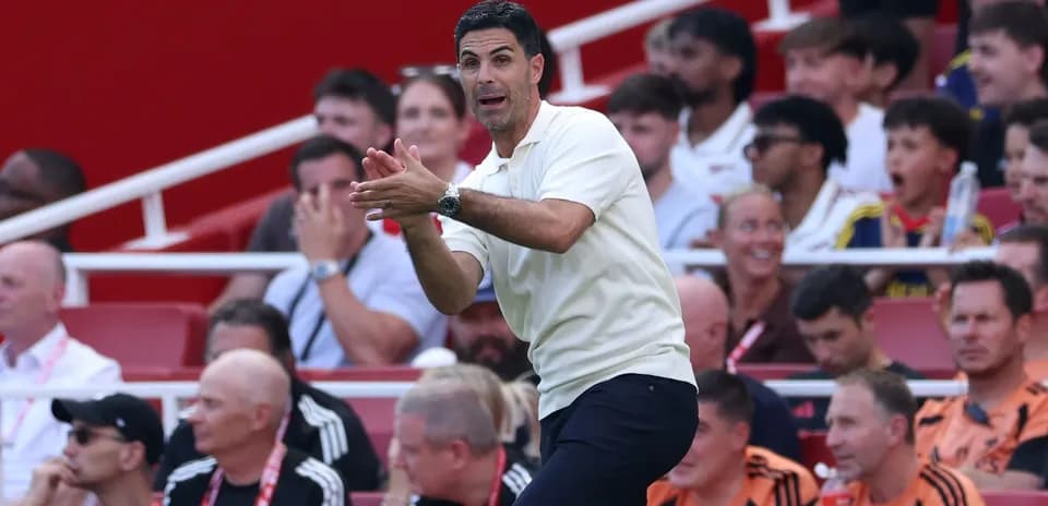 Manager instructing players from the sidelines during match