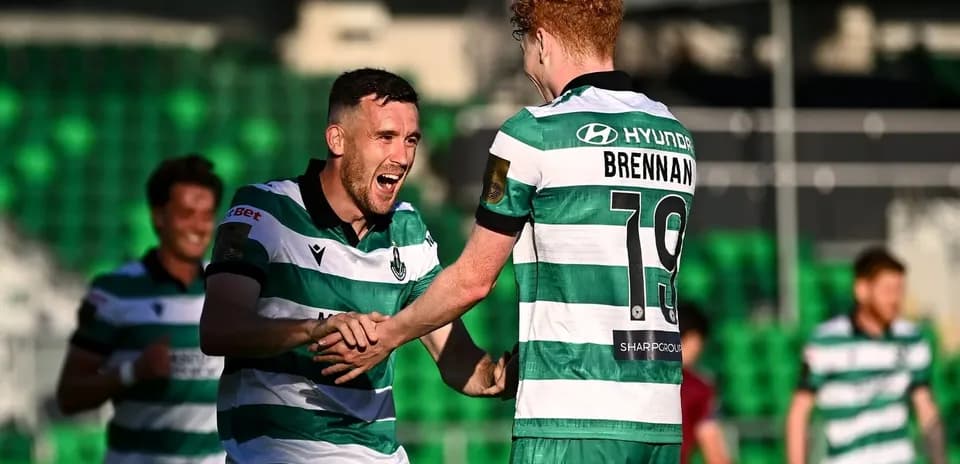 Players celebrating a goal on the field