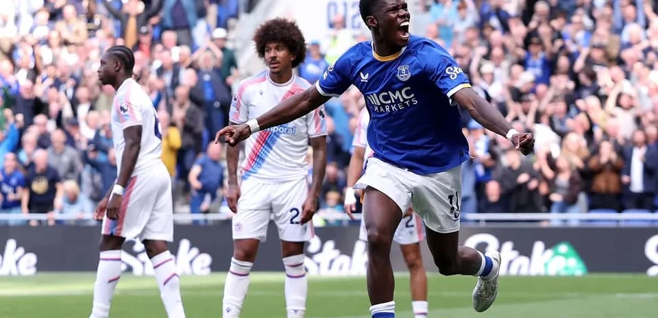 Player celebrating goal with crowd in background