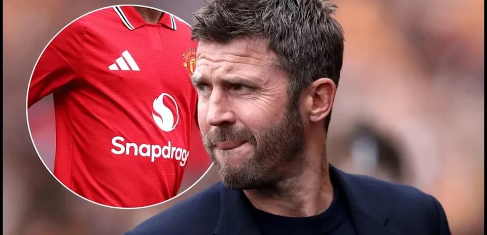 Coach observing match with Manchester United jersey shown
