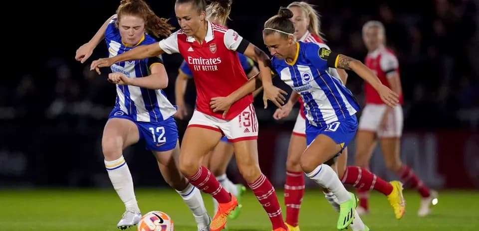 Players competing for the ball in FA WSL match