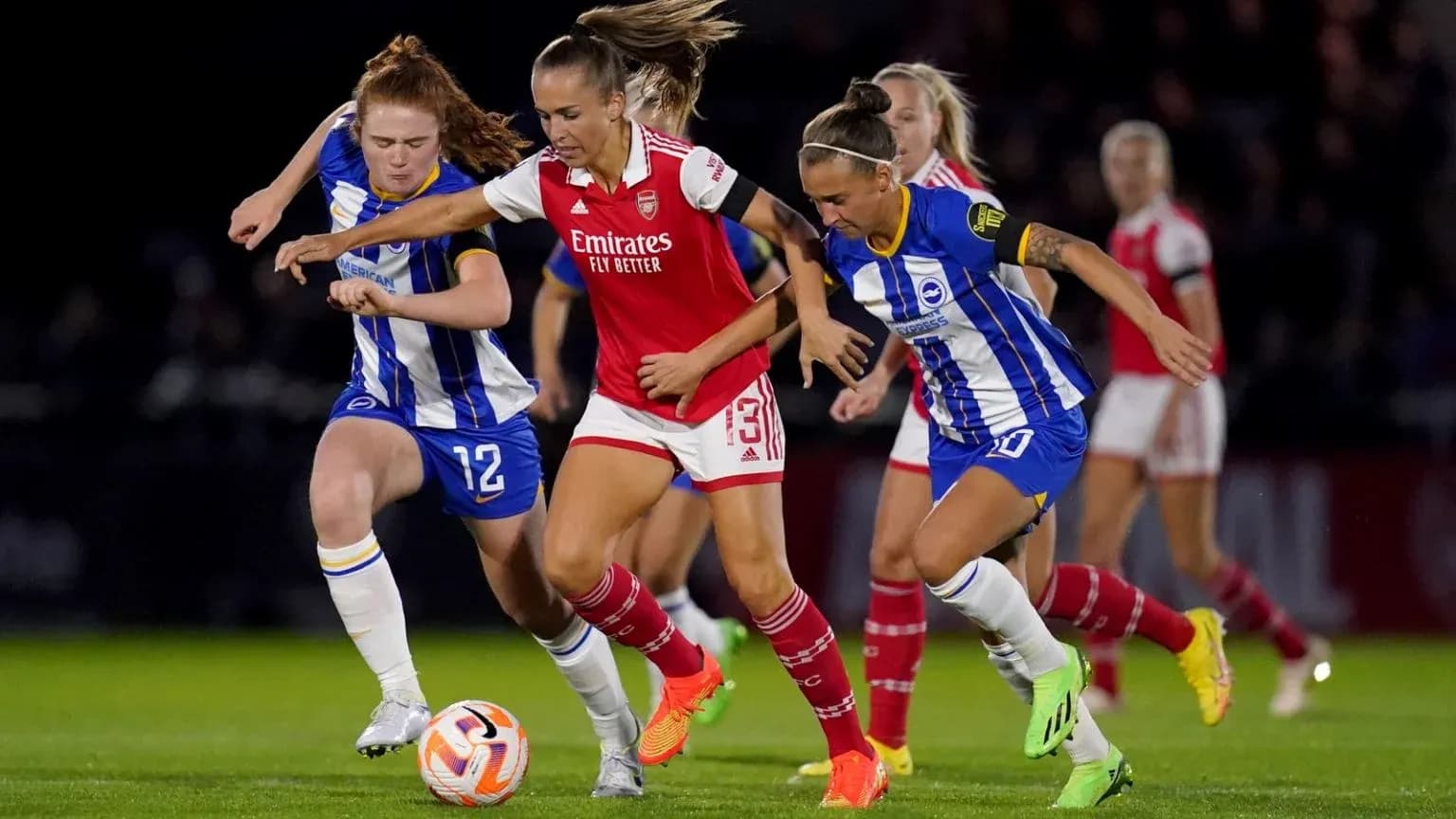Players competing for the ball in FA WSL match