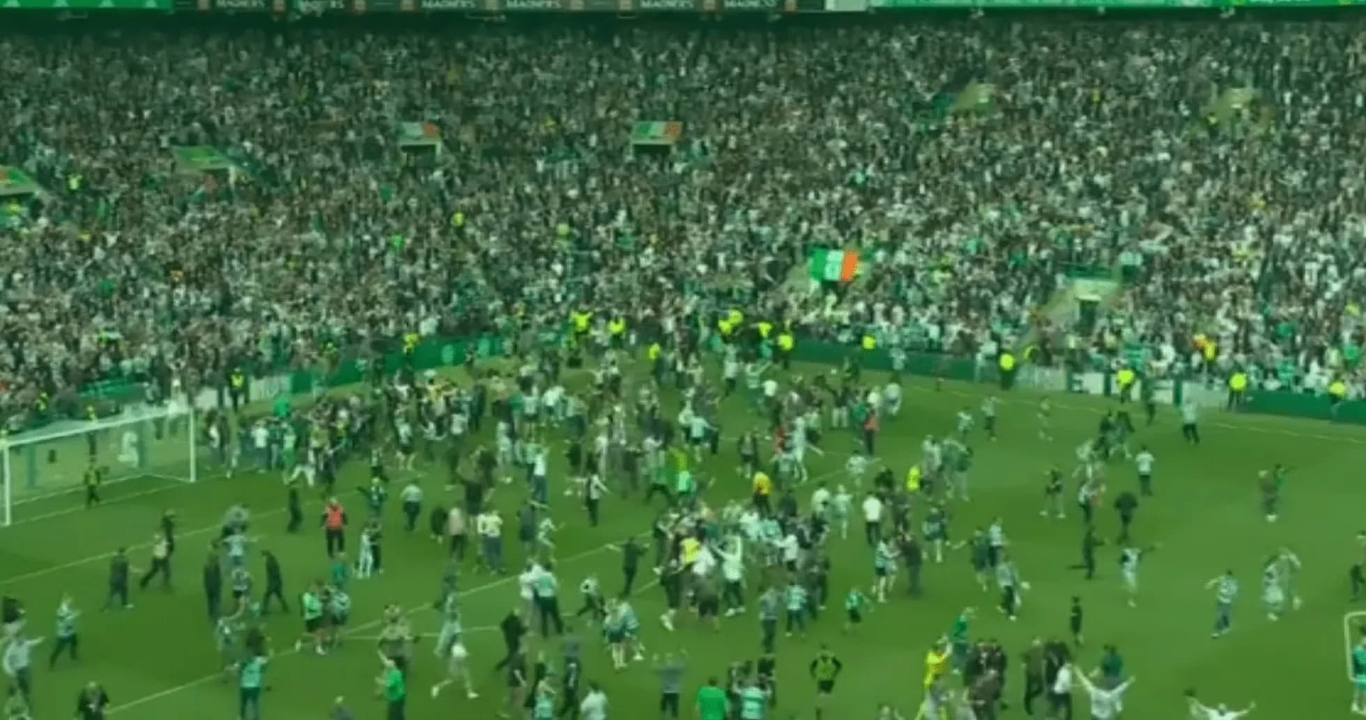 Crowd celebrating on the pitch after a match