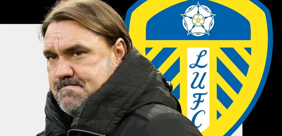 Coach in front of Leeds United logo background