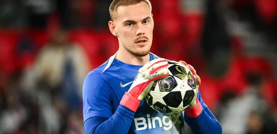 Goalkeeper holding ball before match at stadium