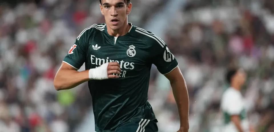 Player running during a match wearing Real Madrid kit