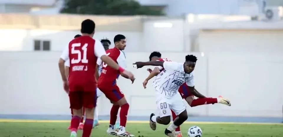 Player dribbling past opponents during U23 match