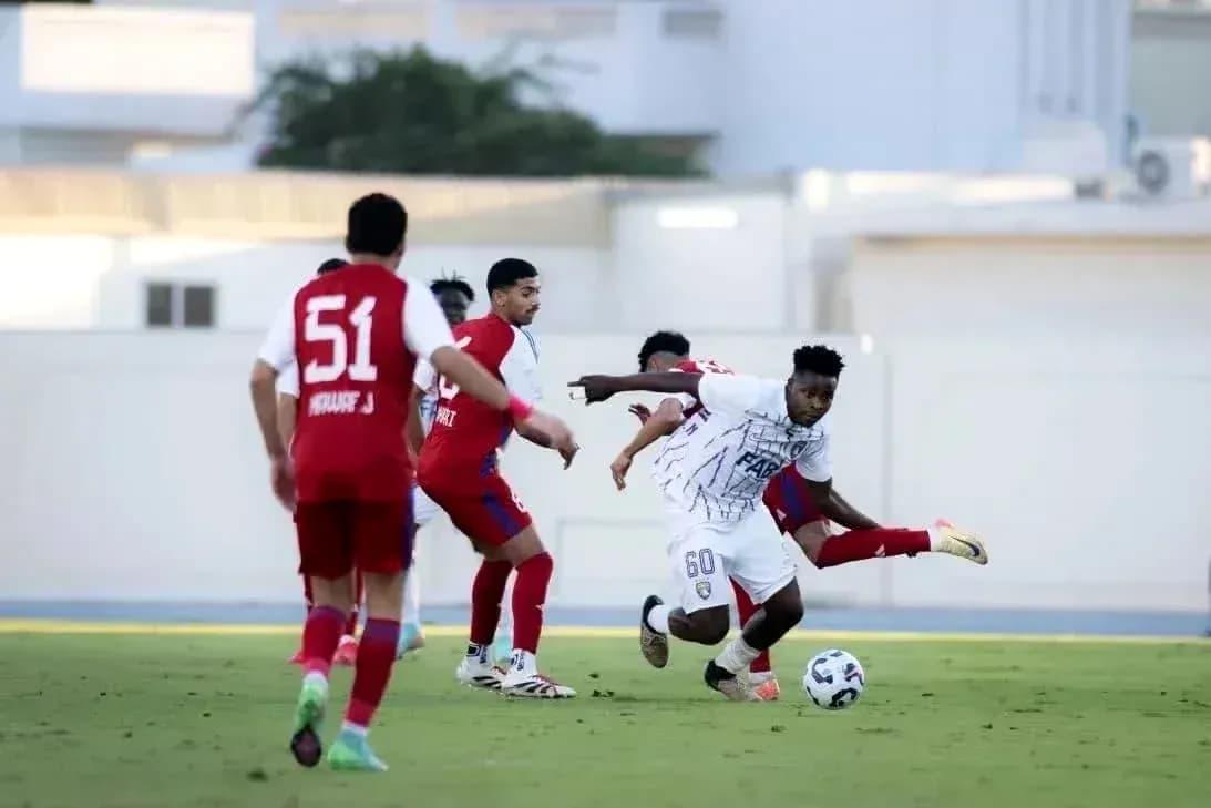 Player dribbling past opponents during U23 match