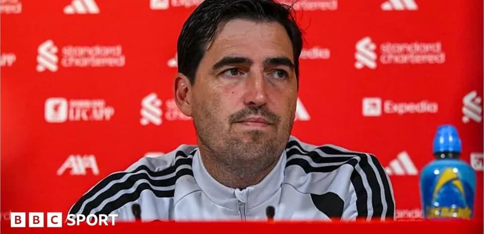 Manager speaking at press conference with sponsor backdrop