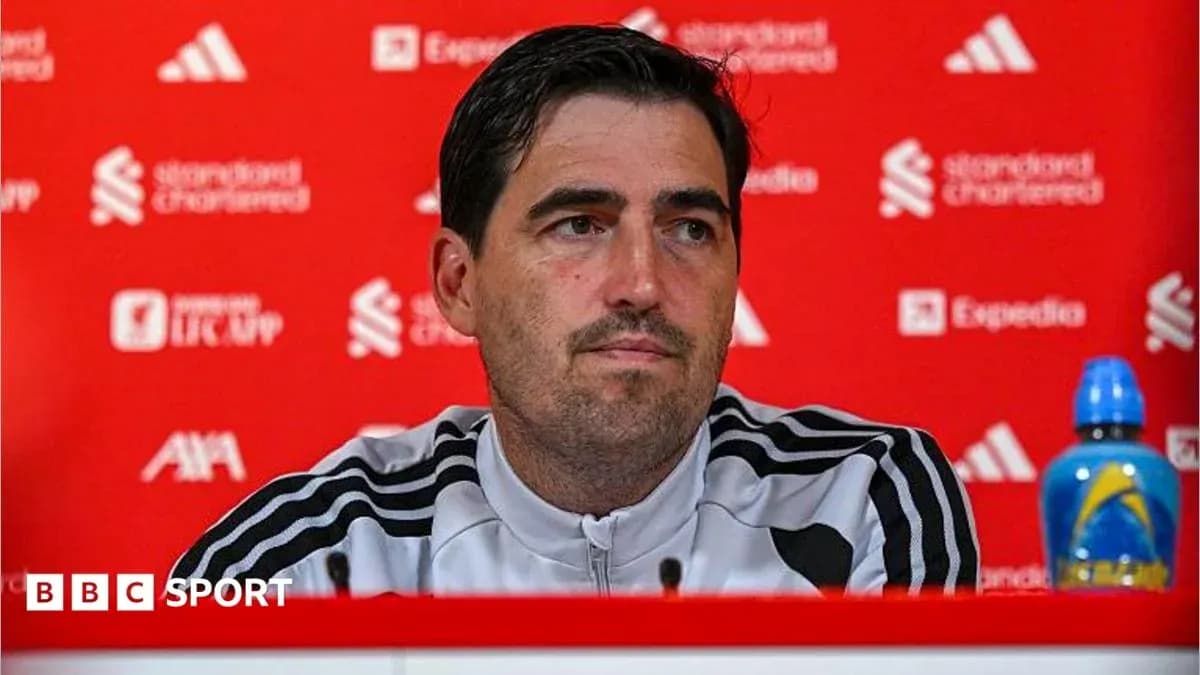 Manager speaking at press conference with sponsor backdrop