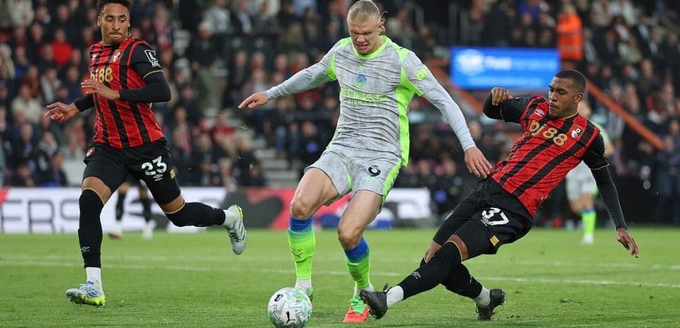 Bournemouth player tackling Manchester City striker