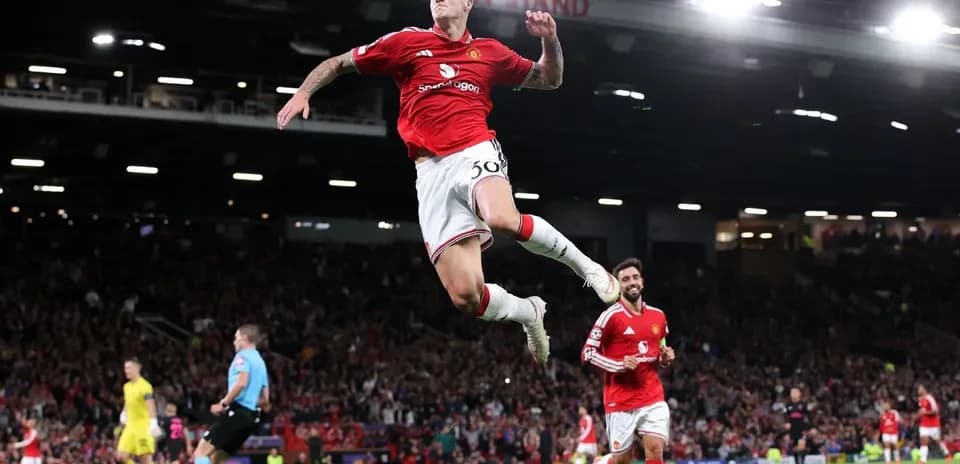 Player celebrating goal with teammates at Old Trafford