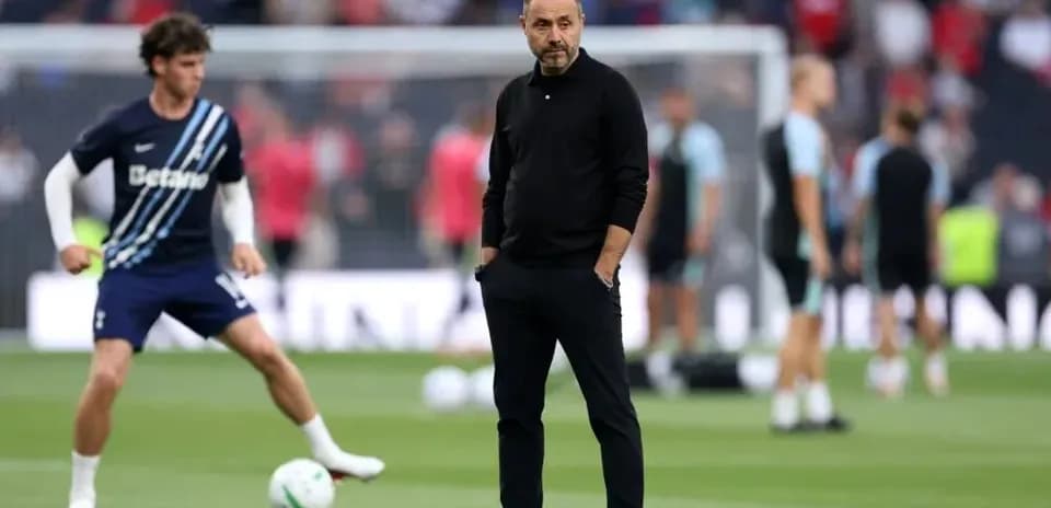 Coach observing players during pre-match warm-up