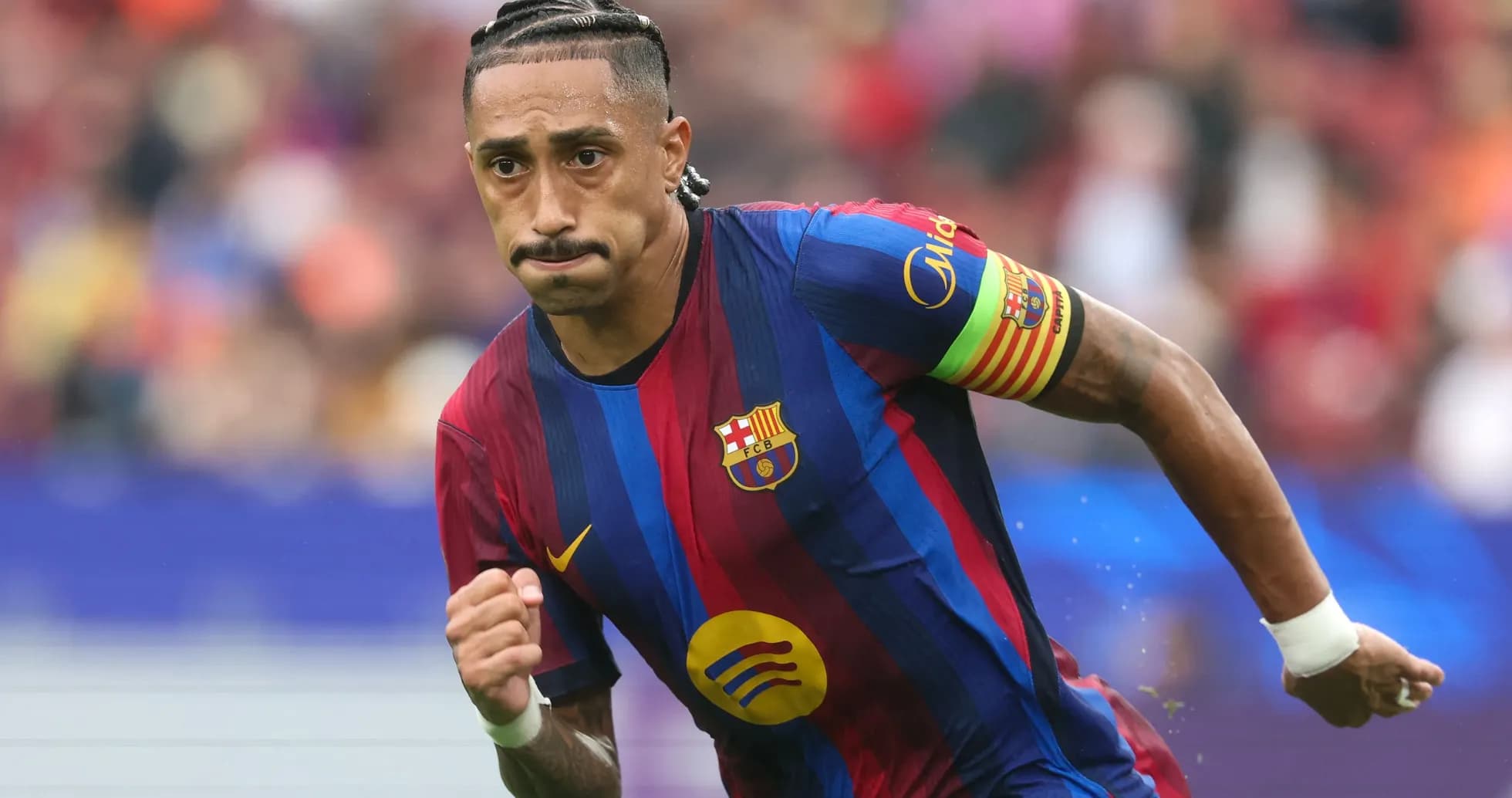 Player running on the pitch wearing Barcelona jersey