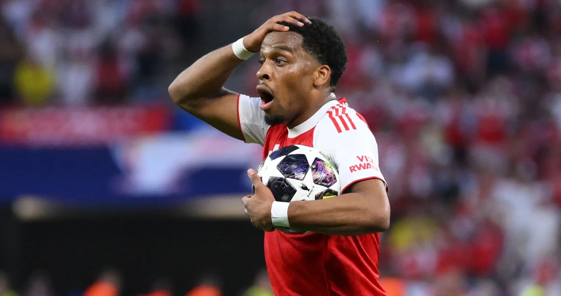 Player holding the ball with a surprised expression