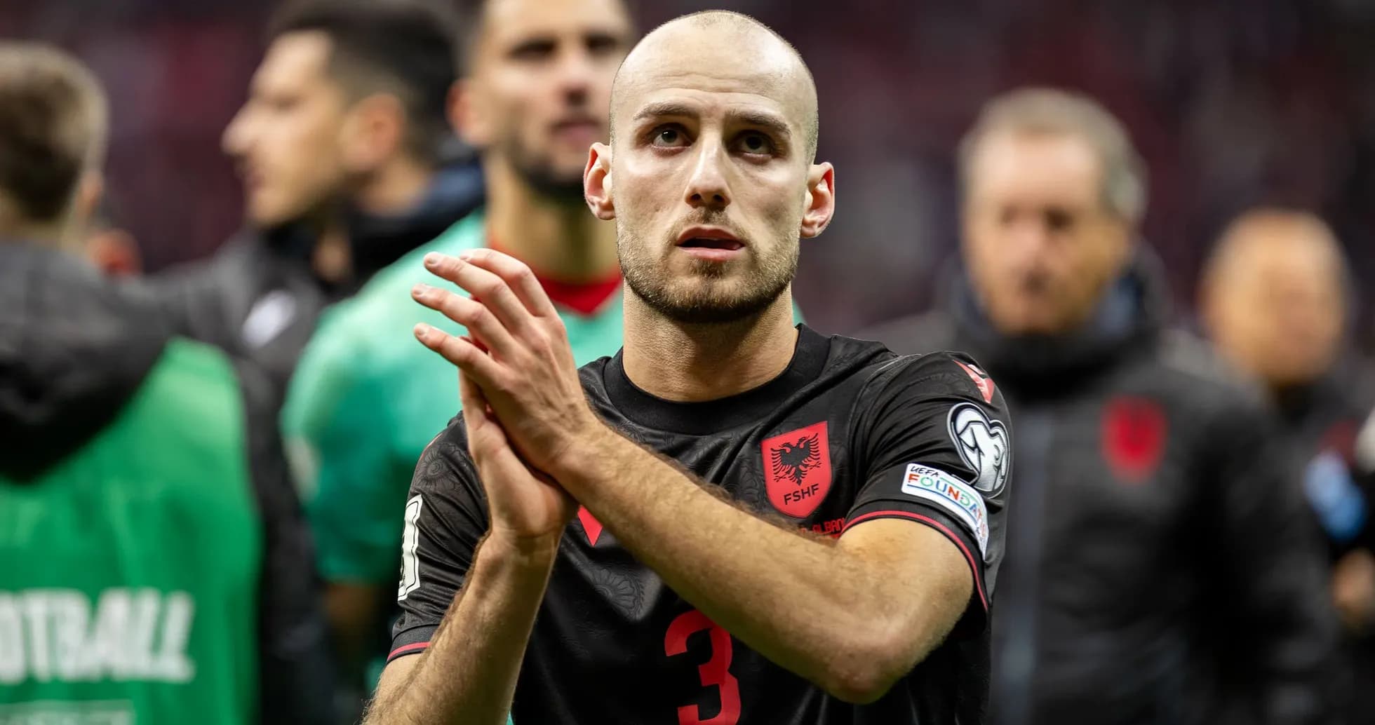 Albanian player applauding fans after a match