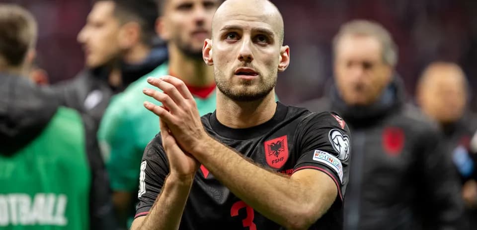 Albanian player applauding fans after a match