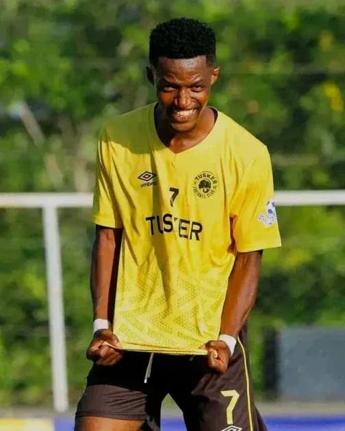 Player celebrating in yellow team jersey on field