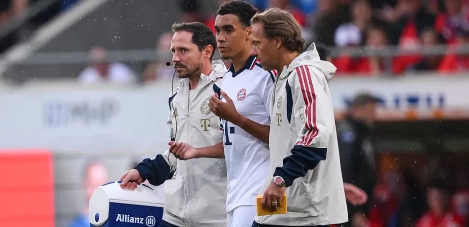 Player receiving medical attention from staff on field